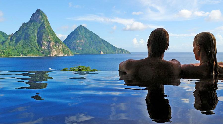 couple in an infinity pool looking at the mountains